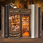 Magic Wand Store book nook tucked between books on a shelf, lit interior visible through open door